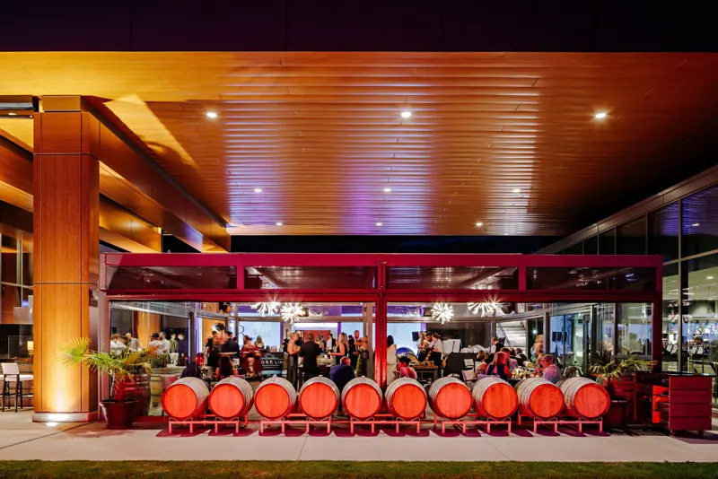 An evening event on the patio under the wood ceiling